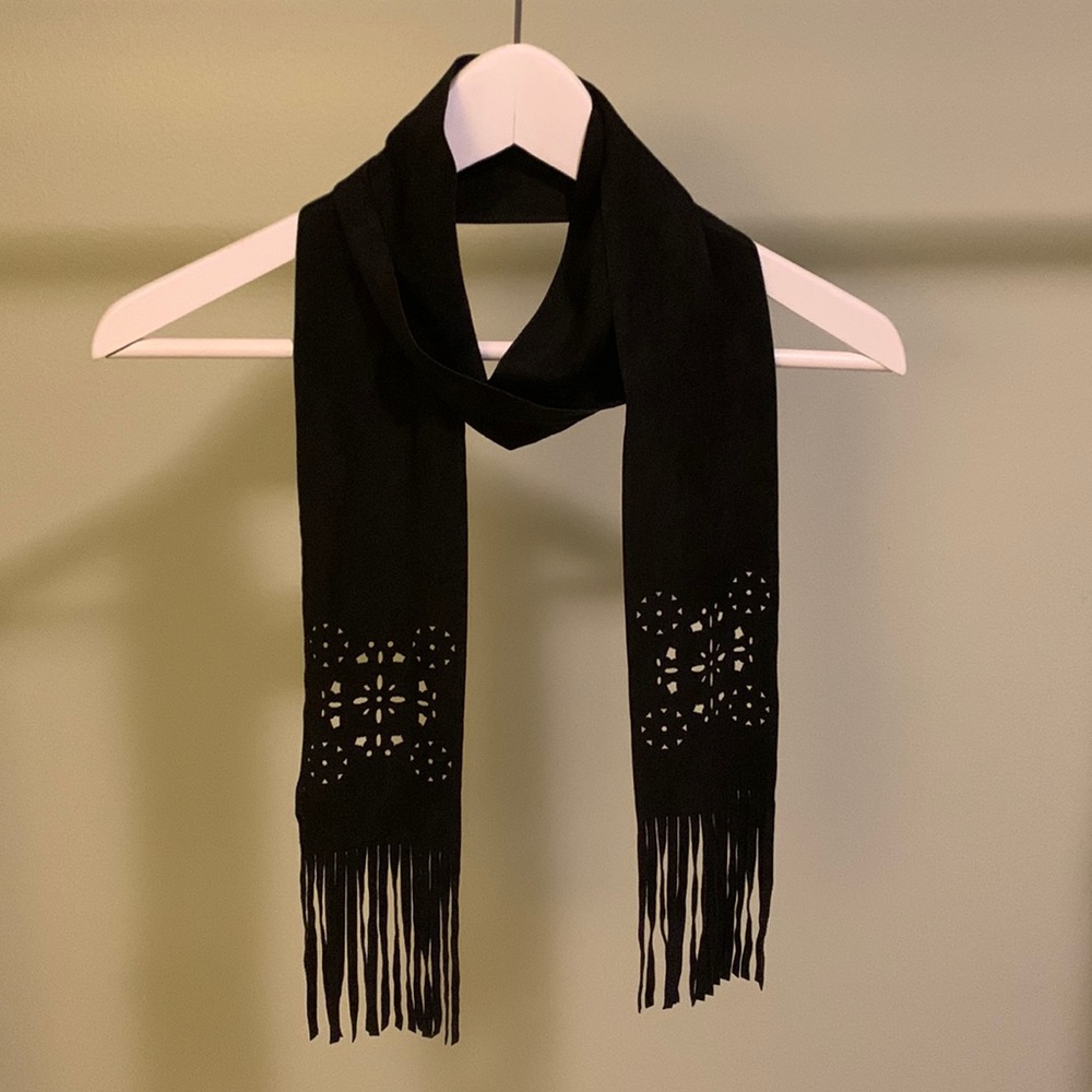Black scarf with floral cut-out design and fringe.